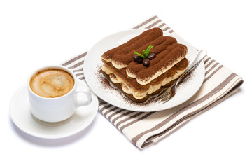 Classic tiramisu dessert on ceramic plate and cup of coffee isolated on white background with clipping path