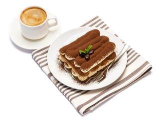 Classic tiramisu dessert on ceramic plate and cup of coffee isolated on white background with clipping path