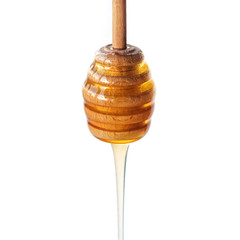 Honey dripping from a wooden dipper