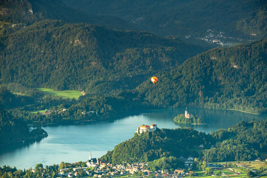 Lake Bled And Castle With A Hot Air Ballon Over Top At Sunrise