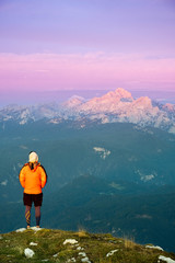 Fototapeta na wymiar Person looking at the Julian alps on a mountain summit in Slovenia