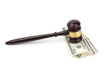 Banknote and judge's hammer with financial concept isolated on white background.