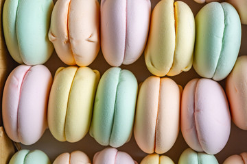 Colored sweet dessert zephyr marshmallows on white background. Air marshmallows. Confectionery.