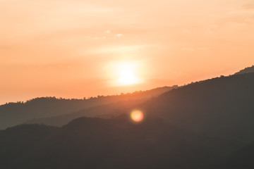 Fototapeta na wymiar At sunset mountain landscape of silhouette. Sun Setting Behind Mountains. Sunset Over Mountain.