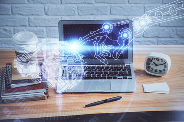 Double exposure of table with computer and brain hologram. Data innovation concept.
