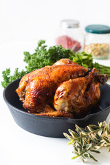 Food concept Roasted, Grilled Whole organic chicken in skillet iron pan on white background