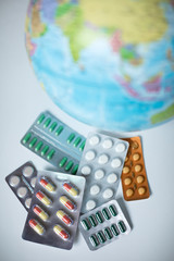 Model of the globe and pills. Concept of pandemic and global virus