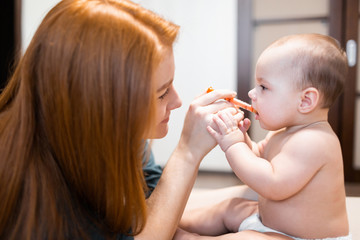 Medicine for baby. The kid receives medicine from a syringe. A mother gives a sick child medicine...