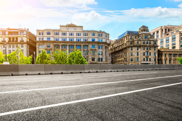 Shanghai old-style buildings and empty asphalt road in summer