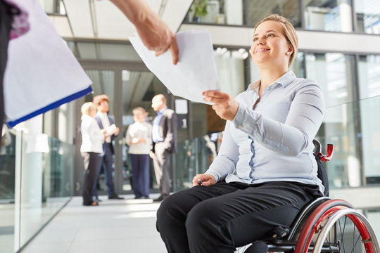 Businesswoman In A Wheelchair Gets Documents