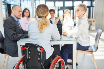 Business woman in a wheelchair in a project meeting