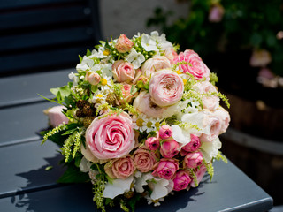 Beautiful bouquet of the bride on a wooden table.