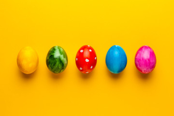 Bright easter eggs on yellow background. Retro colorful spring decoration.