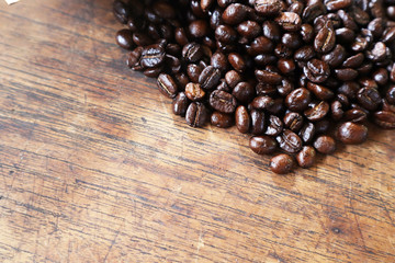 Roasted coffee beans on wood table.