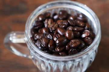 Roasted coffee beans in glass.