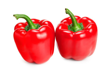 two red sweet bell peppers isolated on white background