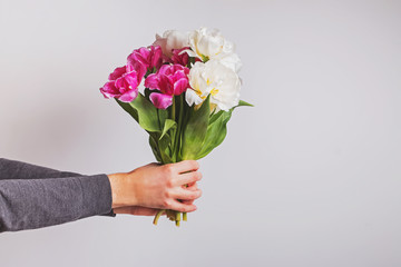Man holding a bouquet with tulip flowers