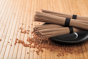 Buckwheat noodles closeup. Raw food ingredient. Dried buckwheat soba noodles. Traditional Japanese food - Image