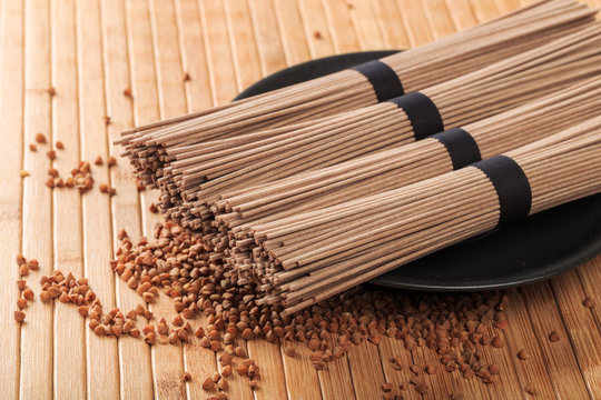 Buckwheat noodles closeup. Raw food ingredient. Dried buckwheat soba noodles. Traditional Japanese food - Image