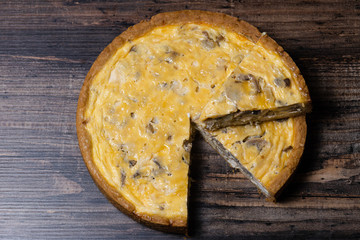 Appetizing kish with chicken and mushrooms on a Wooden Table