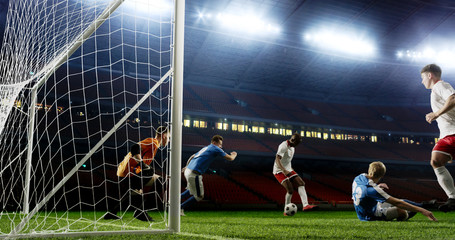 Tense game moment in front of the goal on the empty professional soccer stadium. No spectators on...