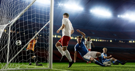 Tense game moment in front of the goal on the empty professional soccer stadium. No spectators on...