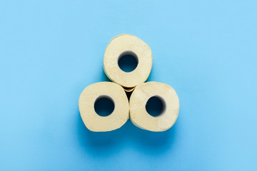 toilet paper rolls on a blue background. Flat lay, top view. Hygiene concept, deficiency, quarantine. Banner.
