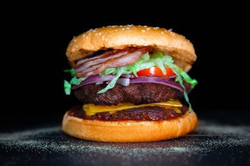 Double bacon cheeseburger with tomato and lettuce