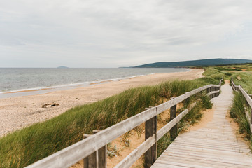 Wood boardwalk at Inverness Beach on the west coast of Cape Breton Island, Nova Scotia, Canada