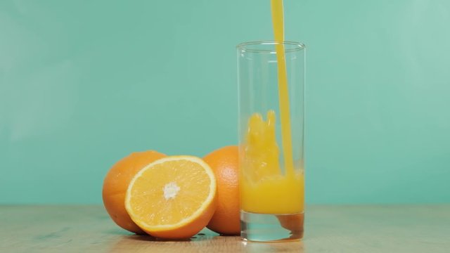 orange juice in glass on blue background