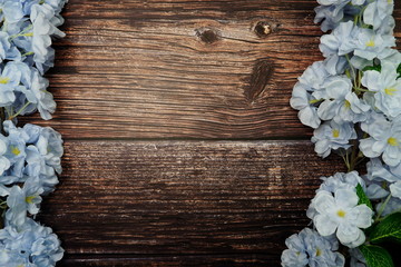 Top view Blooming Flowers frame with copy space on wooden background