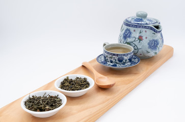 Obraz na płótnie Canvas cup with tea and teapot on white background, Tea concept, over light