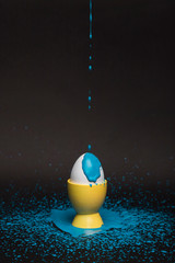 High angle blue painting poured on egg
