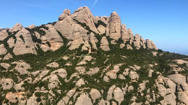 Pan shot of unusual multi-peaked mountain range in Montserrat, Spain