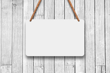 A hanging signboard with rope to a white wooden wall. Textured Mockup and template concept.