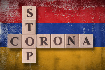 Flag of Armenia with wooden cubes spelling STOP CORONA on it. 2019 - 2020 Novel Coronavirus (2019-nCoV) concept art, for an outbreak occurs in Armenia.