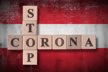 Flag of Austria with wooden cubes spelling STOP CORONA on it. 2019 - 2020 Novel Coronavirus (2019-nCoV) concept art, for an outbreak occurs in Austria.