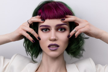 Beautiful woman with purple green professional colored hair