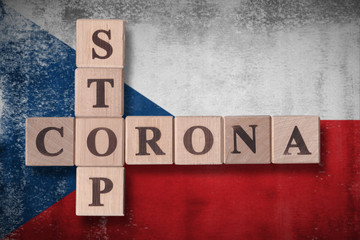 Flag of Czech Republic with wooden cubes spelling STOP CORONA on it. 2019 - 2020 Novel Coronavirus (2019-nCoV) concept art, for an outbreak occurs in Czech Republic.