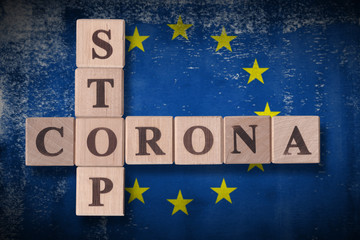 Flag of European Union with wooden cubes spelling STOP CORONA on it. 2019 - 2020 Novel Coronavirus (2019-nCoV) concept art, for an outbreak occurs in Europe.