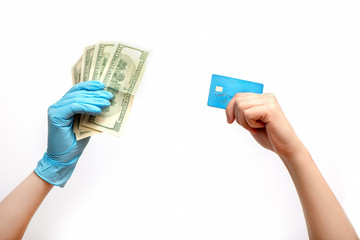 Hand with credit card and hand in medical glove with cash on white background.