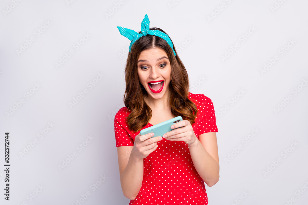 Sticker Portrait of excited crazy funny ginger hair girl use smartphone play video online social media games wear good look blue vintage style outfit isolated over grey color background