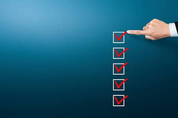 Checklist concept, Businessman checking mark on the check boxes with marker red