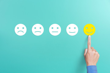 client's hand picked the happy face smile face, Customer service evaluation and satisfaction survey...