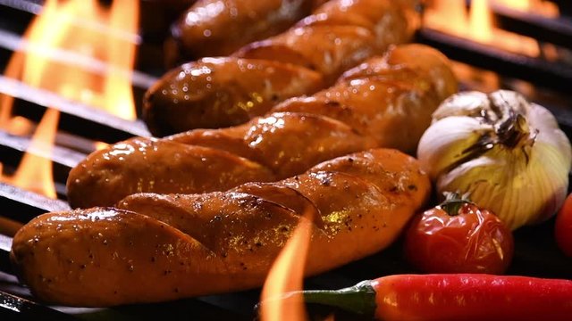 Grilled sausages on the flaming grill