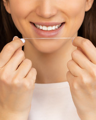 dental floss with a smile and beautiful teeth. flossing