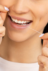 dental floss with a smile and beautiful teeth. flossing