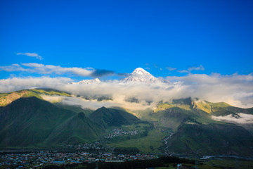 beautiful mountain landscape with fog in Georgia in summer sunny day. wide nature and locality in Georgia. clouds on  blue sky background in mountain 