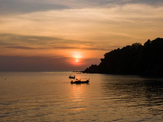 Fototapeta na wymiar Fisherman orange sunset, Thailand island