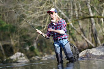 woman fly fishing in river